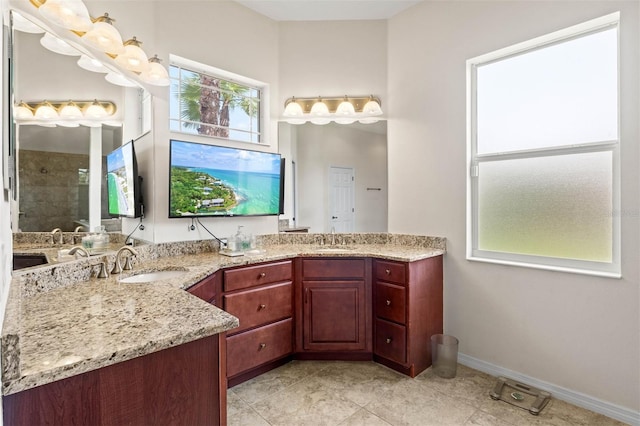 bathroom with vanity and a tile shower