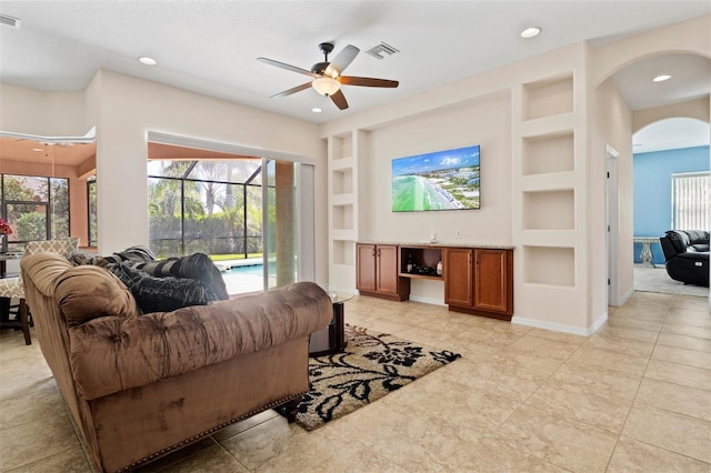 tiled living room featuring built in features and ceiling fan