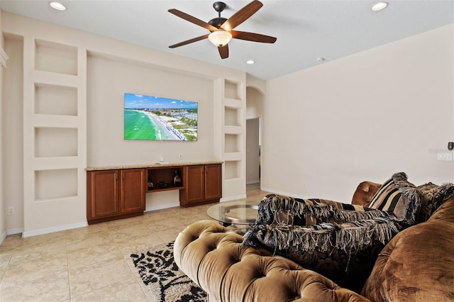 living room with light tile patterned floors, built in features, and ceiling fan