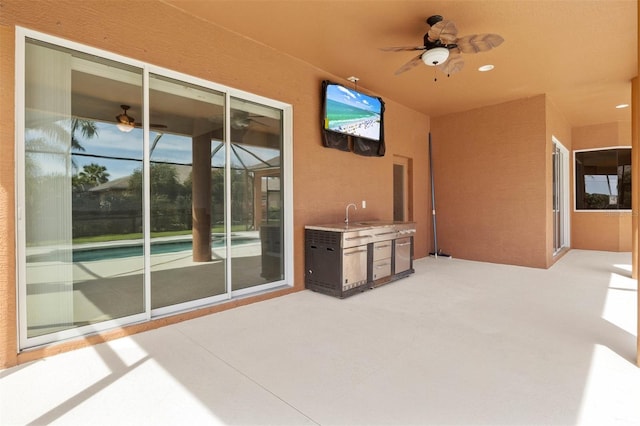 view of patio featuring area for grilling and ceiling fan