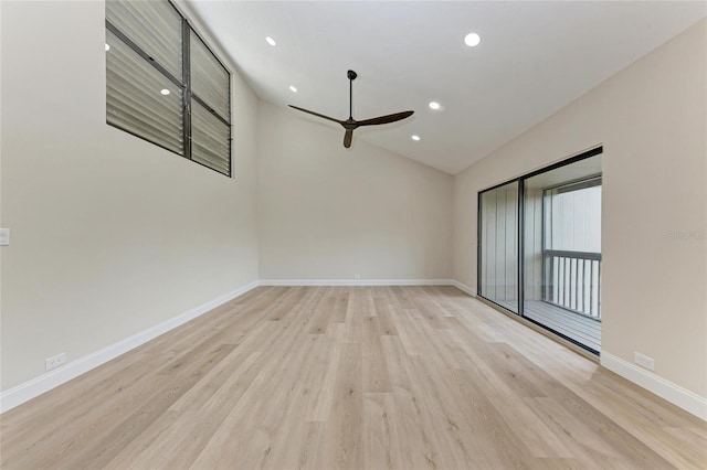 empty room featuring vaulted ceiling, light hardwood / wood-style floors, and ceiling fan