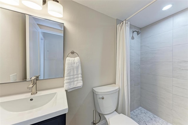 bathroom featuring vanity, curtained shower, and toilet