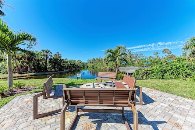 view of patio featuring a water view and an outdoor fire pit