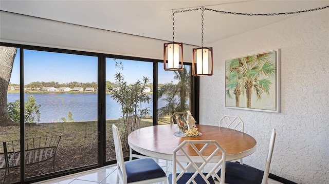 tiled dining space with a water view