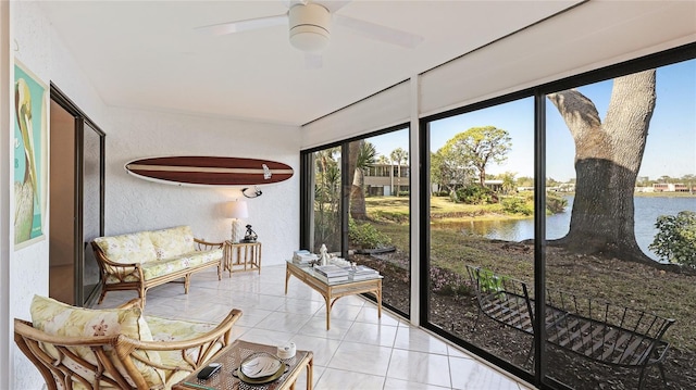 sunroom with a water view and ceiling fan