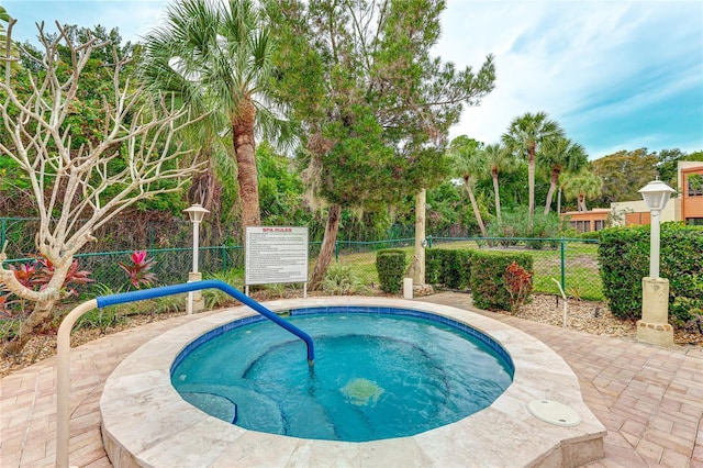 view of pool with a hot tub