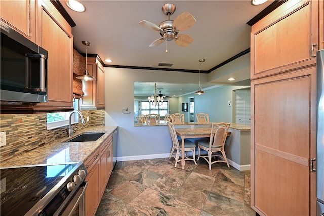 kitchen featuring decorative light fixtures, a sink, stainless steel appliances, crown molding, and backsplash