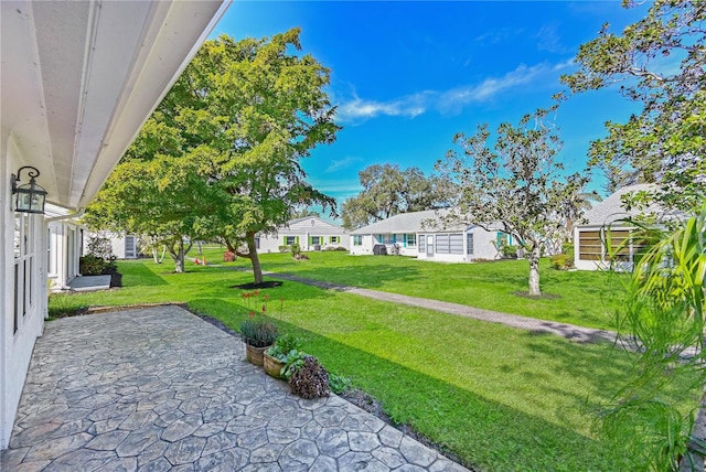 view of yard featuring a residential view and a patio