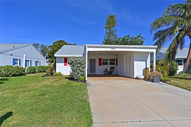 ranch-style house with driveway, a carport, and a front yard