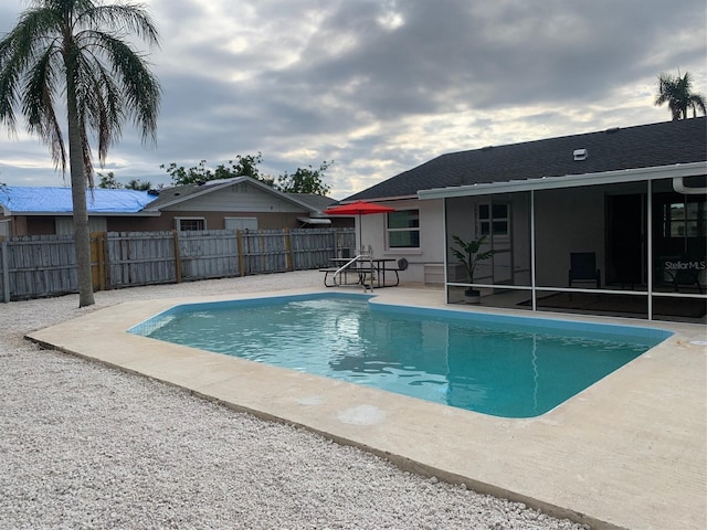 view of pool featuring a sunroom and a patio