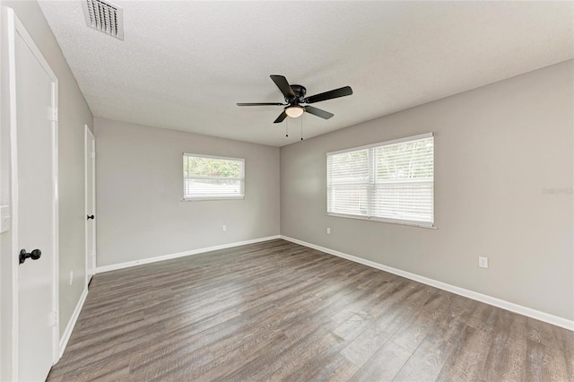 unfurnished room with ceiling fan, hardwood / wood-style flooring, and a textured ceiling