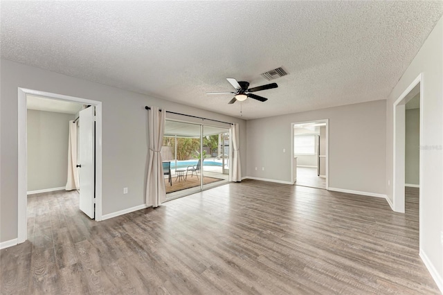 empty room featuring ceiling fan, light hardwood / wood-style flooring, and a textured ceiling