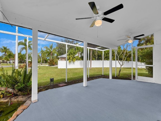 unfurnished sunroom featuring ceiling fan