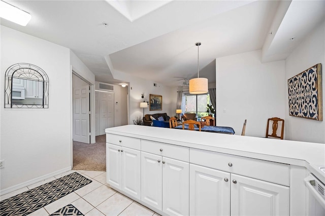 kitchen featuring decorative light fixtures, light tile patterned floors, and white cabinets