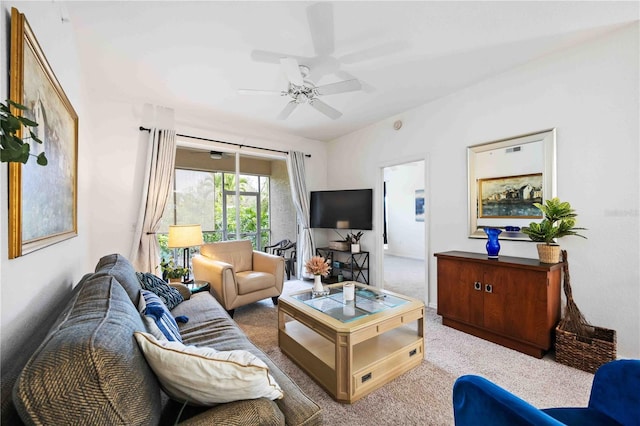 carpeted living room with ceiling fan