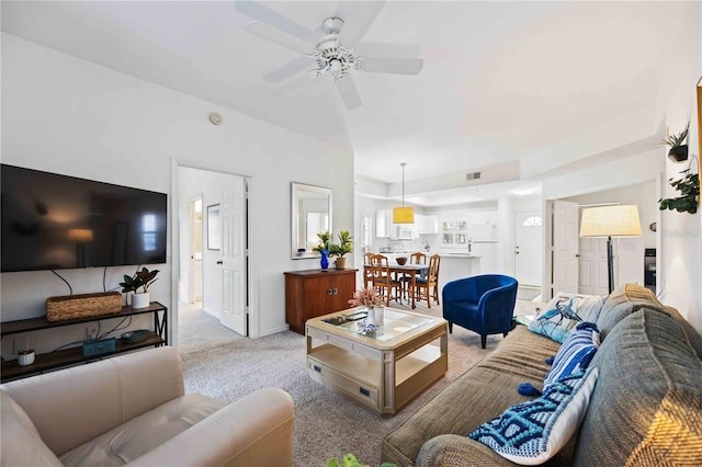 living room featuring light colored carpet and ceiling fan