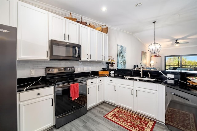 kitchen featuring white cabinetry, appliances with stainless steel finishes, crown molding, and sink