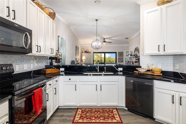 kitchen featuring sink, crown molding, black appliances, kitchen peninsula, and white cabinets