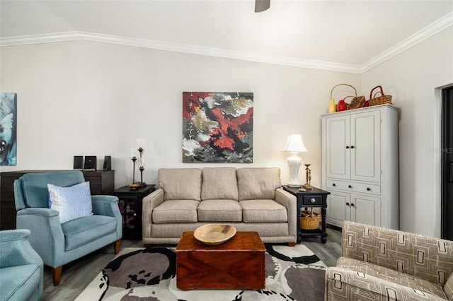 living room with ornamental molding, vaulted ceiling, and light wood-type flooring