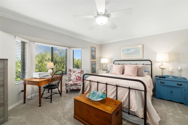 carpeted bedroom featuring crown molding and ceiling fan