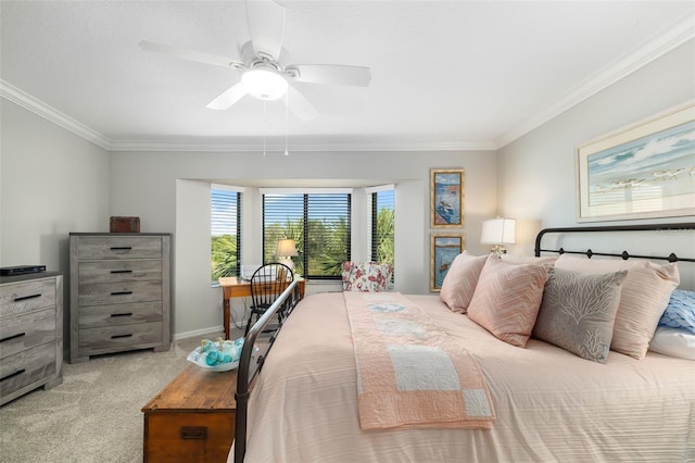 carpeted bedroom with ornamental molding and ceiling fan