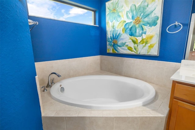 bathroom with vanity and tiled tub