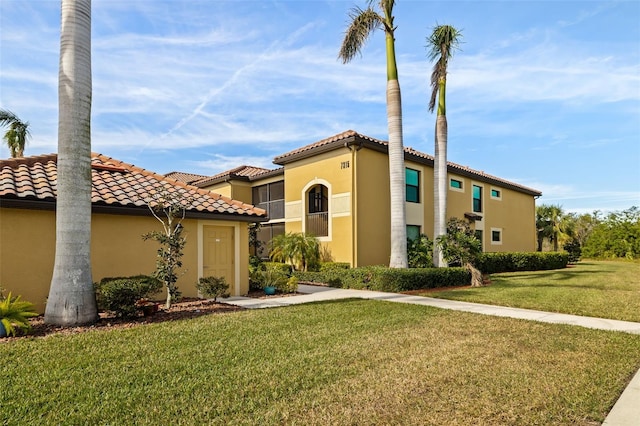 mediterranean / spanish home featuring a front yard