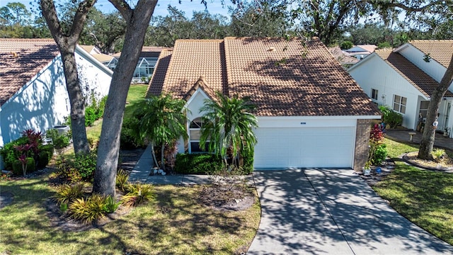 view of front of house featuring a garage and a front lawn