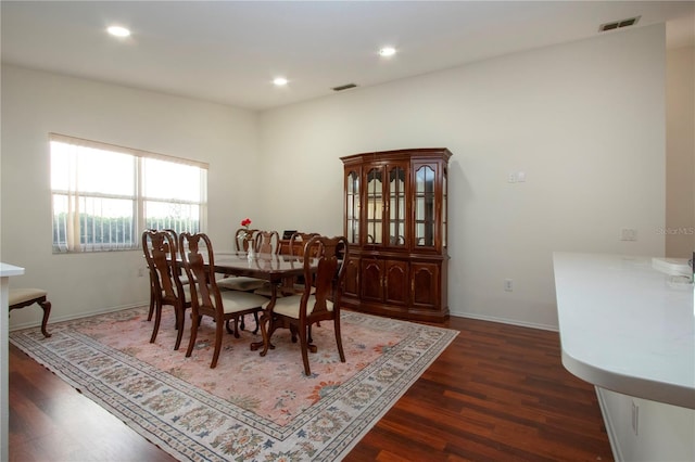 dining space with dark hardwood / wood-style flooring