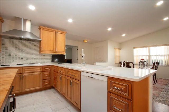 kitchen with kitchen peninsula, wooden counters, white appliances, and wall chimney exhaust hood