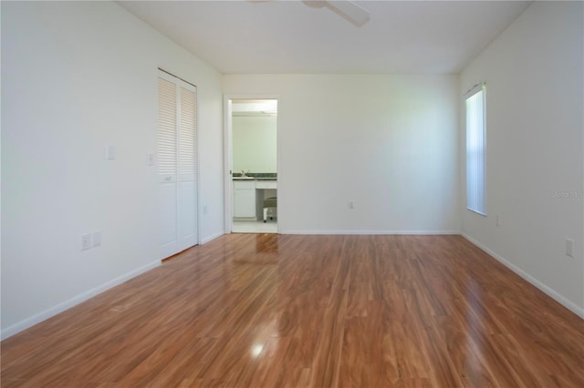 spare room featuring hardwood / wood-style flooring and ceiling fan