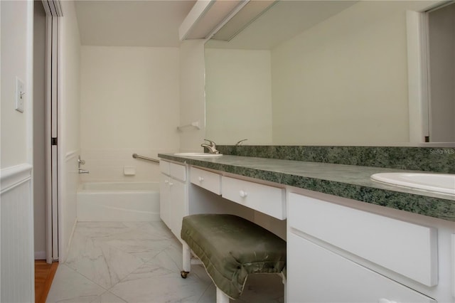 bathroom with vanity and a tub