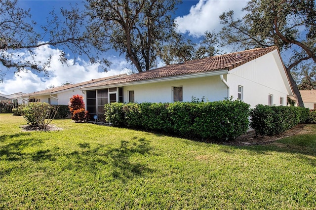 rear view of property featuring a lawn