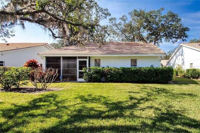 back of house with a sunroom and a yard