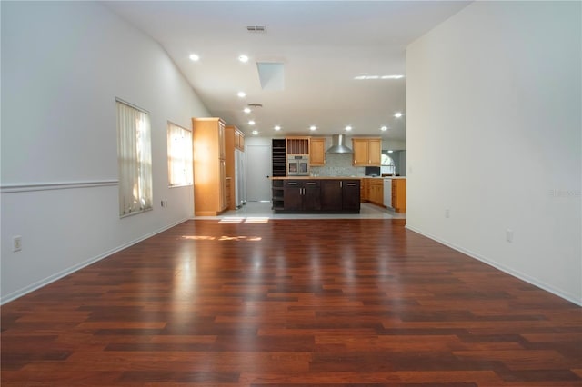 unfurnished living room featuring dark hardwood / wood-style floors and high vaulted ceiling