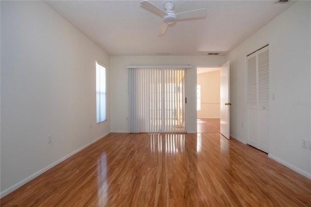 unfurnished room featuring ceiling fan and light wood-type flooring