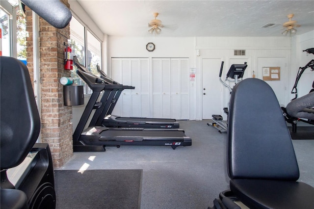 exercise area featuring a textured ceiling and ceiling fan