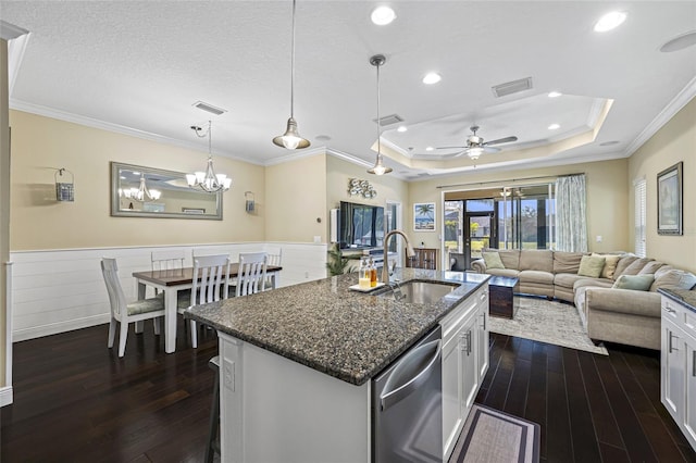 kitchen featuring white cabinetry, a kitchen island with sink, sink, and stainless steel dishwasher