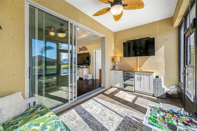 sunroom / solarium featuring wine cooler and ceiling fan