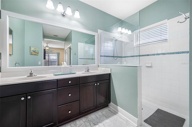 bathroom featuring a tile shower and vanity