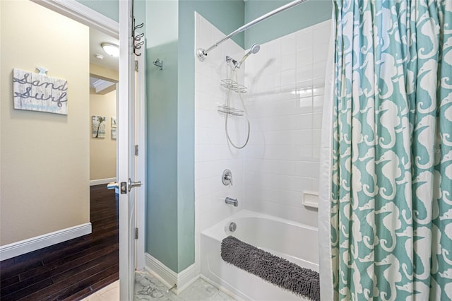 bathroom with hardwood / wood-style floors and shower / bath combo with shower curtain