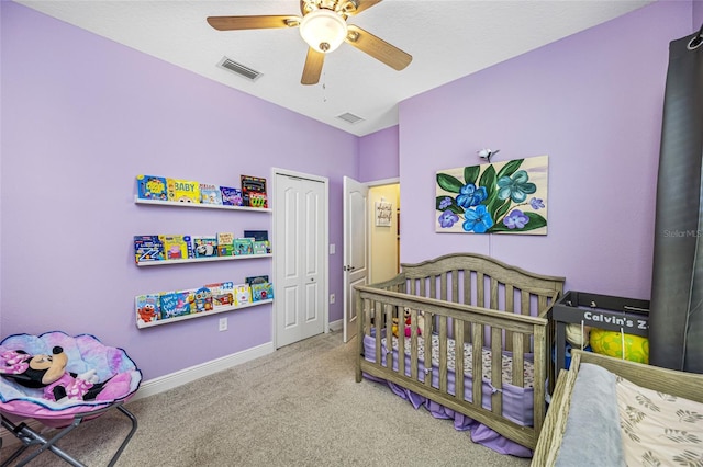 carpeted bedroom with ceiling fan and a closet