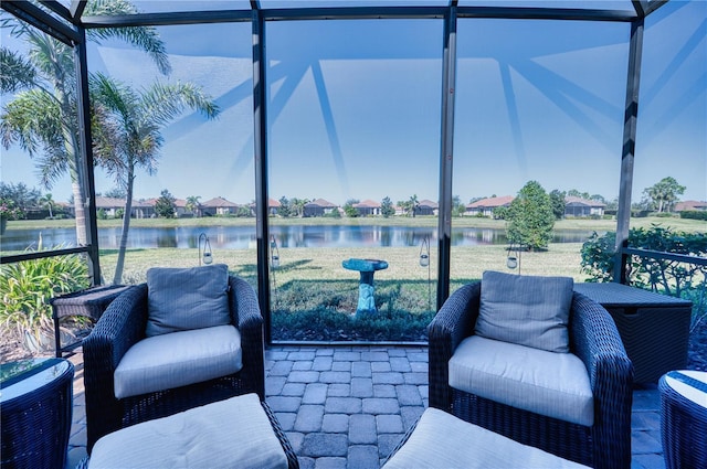 sunroom / solarium featuring a water view