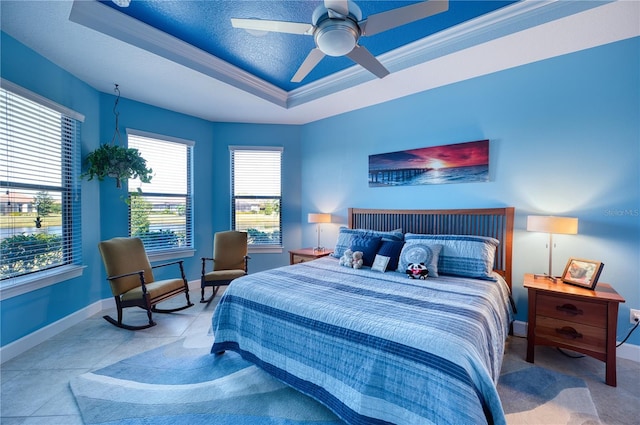 bedroom featuring crown molding, ceiling fan, a tray ceiling, and a textured ceiling