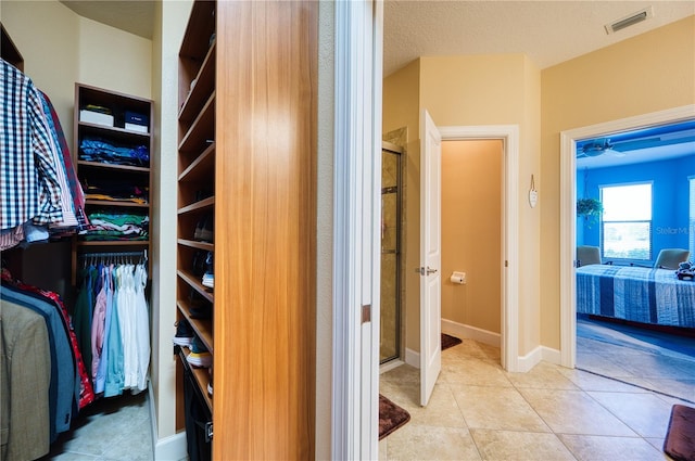 walk in closet with light tile patterned flooring