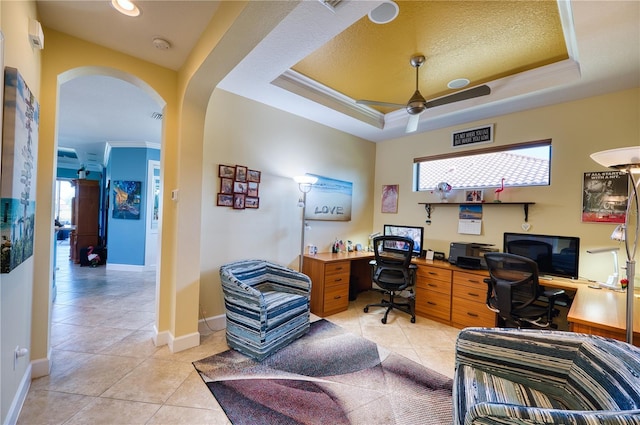 tiled home office with a raised ceiling, ornamental molding, and ceiling fan