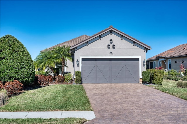 view of front facade featuring a garage and a front lawn