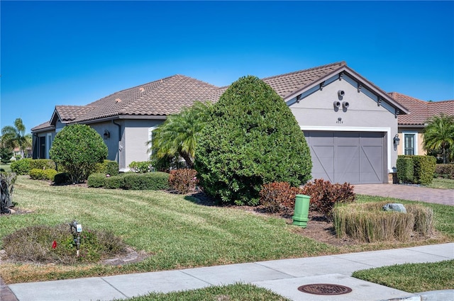 mediterranean / spanish-style house with a garage and a front lawn