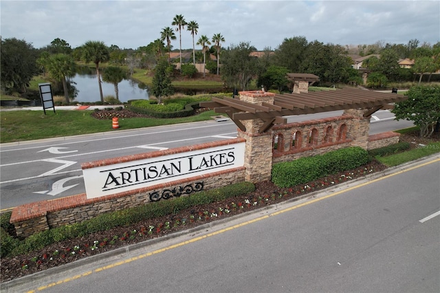 community / neighborhood sign featuring a water view