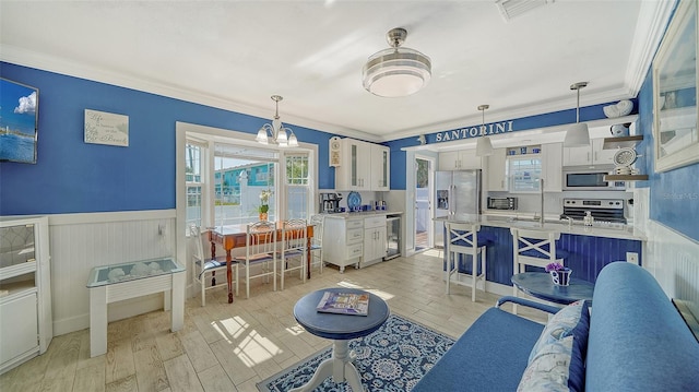 living room featuring crown molding, beverage cooler, and light hardwood / wood-style flooring